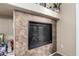 Close up view of a fireplace with tile surround and decorative shelving at 4511 W Valencia Dr, Laveen, AZ 85339