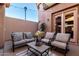 Relaxing covered patio featuring comfortable seating, plants, and views of the yard at 4511 W Valencia Dr, Laveen, AZ 85339