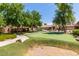 This putting green offers a sand trap for a more challenging experience for community members at 4511 W Valencia Dr, Laveen, AZ 85339