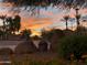 Picturesque streetscape featuring palm trees, desert landscaping, and vibrant sunset colors at 4511 W Valencia Dr, Laveen, AZ 85339