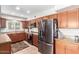 Galley kitchen with wood cabinets, granite counters, and stainless steel appliances at 4543 W Lane Ave, Glendale, AZ 85301