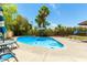 Inviting kidney-shaped pool with patio furniture and umbrella in backyard at 4543 W Lane Ave, Glendale, AZ 85301