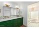 Elegant bathroom with a double vanity, green cabinets, and patterned tile floor at 4622 E Palo Verde Dr, Phoenix, AZ 85018