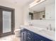 Modern bathroom with double vanity, blue cabinets, and patterned tile floor at 4622 E Palo Verde Dr, Phoenix, AZ 85018