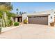 Attached garage with a brown door and desert landscaping at 4622 E Palo Verde Dr, Phoenix, AZ 85018