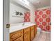 Neat bathroom with orange patterned shower curtain and wood vanity at 520 S Greenfield Rd # 20, Mesa, AZ 85206