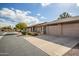 Tan two-car garage with paved driveway and landscaping at 520 S Greenfield Rd # 20, Mesa, AZ 85206