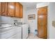 Bright laundry room with washer, dryer, and ample wood cabinets at 520 S Greenfield Rd # 20, Mesa, AZ 85206