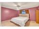 Bedroom with a bed, ceiling fan, and mauve walls at 526 N Hobson Plz, Mesa, AZ 85203