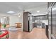 Kitchen features dark wood cabinets, stainless steel appliances, and a view into dining area at 526 N Hobson Plz, Mesa, AZ 85203