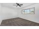 Bright bedroom with ceiling fan and neutral carpeting at 5919 S Lakeshore Dr, Tempe, AZ 85283