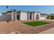 Newly remodeled single story home with artificial turf and rock landscaping at 5919 S Lakeshore Dr, Tempe, AZ 85283