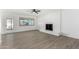 Living room featuring a white brick fireplace, wood-look floors, and sliding glass doors at 5919 S Lakeshore Dr, Tempe, AZ 85283