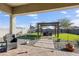 Relaxing backyard oasis with pergola, artificial turf, and patio seating at 5933 N 189Th Dr, Litchfield Park, AZ 85340