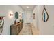 Bright entryway with wood console table, mirror, and tile flooring at 5933 N 189Th Dr, Litchfield Park, AZ 85340