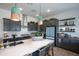 Modern kitchen with gray cabinets, white countertops, and island at 5933 N 189Th Dr, Litchfield Park, AZ 85340