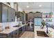 Modern kitchen with gray cabinets, stainless steel appliances, and white countertops at 5933 N 189Th Dr, Litchfield Park, AZ 85340