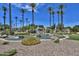 Gated community entrance with a water feature and palm trees at 6118 N 183Rd Ave, Waddell, AZ 85355