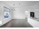 Bright dining area with tile floors and modern chandelier at 6118 N 183Rd Ave, Waddell, AZ 85355