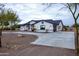 Exterior of house with driveway and desert landscaping at 6118 N 183Rd Ave, Waddell, AZ 85355