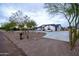 Landscaped yard with a single story home and rock border at 6118 N 183Rd Ave, Waddell, AZ 85355