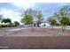 Front yard view of a one-story house with trees at 6118 N 183Rd Ave, Waddell, AZ 85355