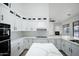 Modern kitchen with white cabinets, quartz countertops, and island at 6118 N 183Rd Ave, Waddell, AZ 85355