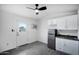 Small kitchen with white cabinets, sink, and refrigerator at 6118 N 183Rd Ave, Waddell, AZ 85355