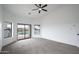 Main bedroom with carpet, sliding glass doors, and pool view at 6118 N 183Rd Ave, Waddell, AZ 85355