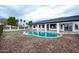 Modern kidney-shaped pool with surrounding patio at 6118 N 183Rd Ave, Waddell, AZ 85355