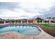 Inviting kidney-shaped pool with rock landscaping and mountain views at 6118 N 183Rd Ave, Waddell, AZ 85355