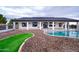 Kidney-shaped pool with a patio and landscaping at 6118 N 183Rd Ave, Waddell, AZ 85355