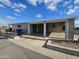 Tan exterior home with covered carport and landscaped yard at 650 N Hawes Rd # 4820, Mesa, AZ 85207