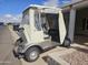 Grey golf cart with beige top parked in driveway at 650 N Hawes Rd # 4820, Mesa, AZ 85207