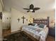 Main bedroom with king bed, ceiling fan, and wooden floors at 650 N Hawes Rd # 4820, Mesa, AZ 85207