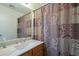 Clean bathroom, marble vanity, and updated shower curtain at 6610 E University Dr # 157, Mesa, AZ 85205