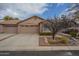 Attractive tan two-car garage home with landscaping at 6610 E University Dr # 157, Mesa, AZ 85205