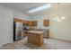 Kitchen with island, wood cabinets, and skylight at 6610 E University Dr # 157, Mesa, AZ 85205