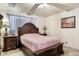 Main bedroom with a large bed, wood furniture, and ceiling fan at 6725 E Moreland St, Scottsdale, AZ 85257