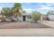 White brick ranch home with palm trees and rock landscaping at 6725 E Moreland St, Scottsdale, AZ 85257