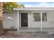 Front entrance with black door and white brick facade at 6725 E Moreland St, Scottsdale, AZ 85257