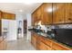 View of kitchen with wood cabinets, granite counters, and stainless steel appliances at 6725 E Moreland St, Scottsdale, AZ 85257