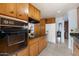 Mid-century kitchen features wood cabinets, granite countertops, and built-in appliances at 6725 E Moreland St, Scottsdale, AZ 85257