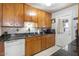 Kitchen featuring wood cabinets, granite counters and a door to backyard at 6725 E Moreland St, Scottsdale, AZ 85257