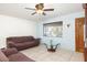 Living area with brown couches, coffee table, and ceiling fan at 6725 E Moreland St, Scottsdale, AZ 85257