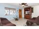 Living room with brown sofas, wood cabinet and ceiling fan at 6725 E Moreland St, Scottsdale, AZ 85257