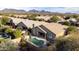 Aerial view of home showcasing pool, patio, desert landscaping and mountain views in community at 7654 E Quill Ln, Scottsdale, AZ 85255