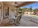 Covered back patio featuring a dining table and chairs overlooking the pool and backyard at 7654 E Quill Ln, Scottsdale, AZ 85255