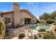 Backyard showcasing pool, covered patio and landscaping with desert foliage and chairs for lounging at 7654 E Quill Ln, Scottsdale, AZ 85255