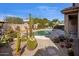 Desert landscaped backyard with cacti, a freeform pool, and a stone border surrounding the perimeter at 7654 E Quill Ln, Scottsdale, AZ 85255